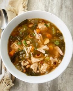 overhead shot of soul food soup in a white bowl