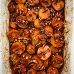 overhead shot of cooked crockpot sweet potato casserole in a white casserole shaped slow cooker