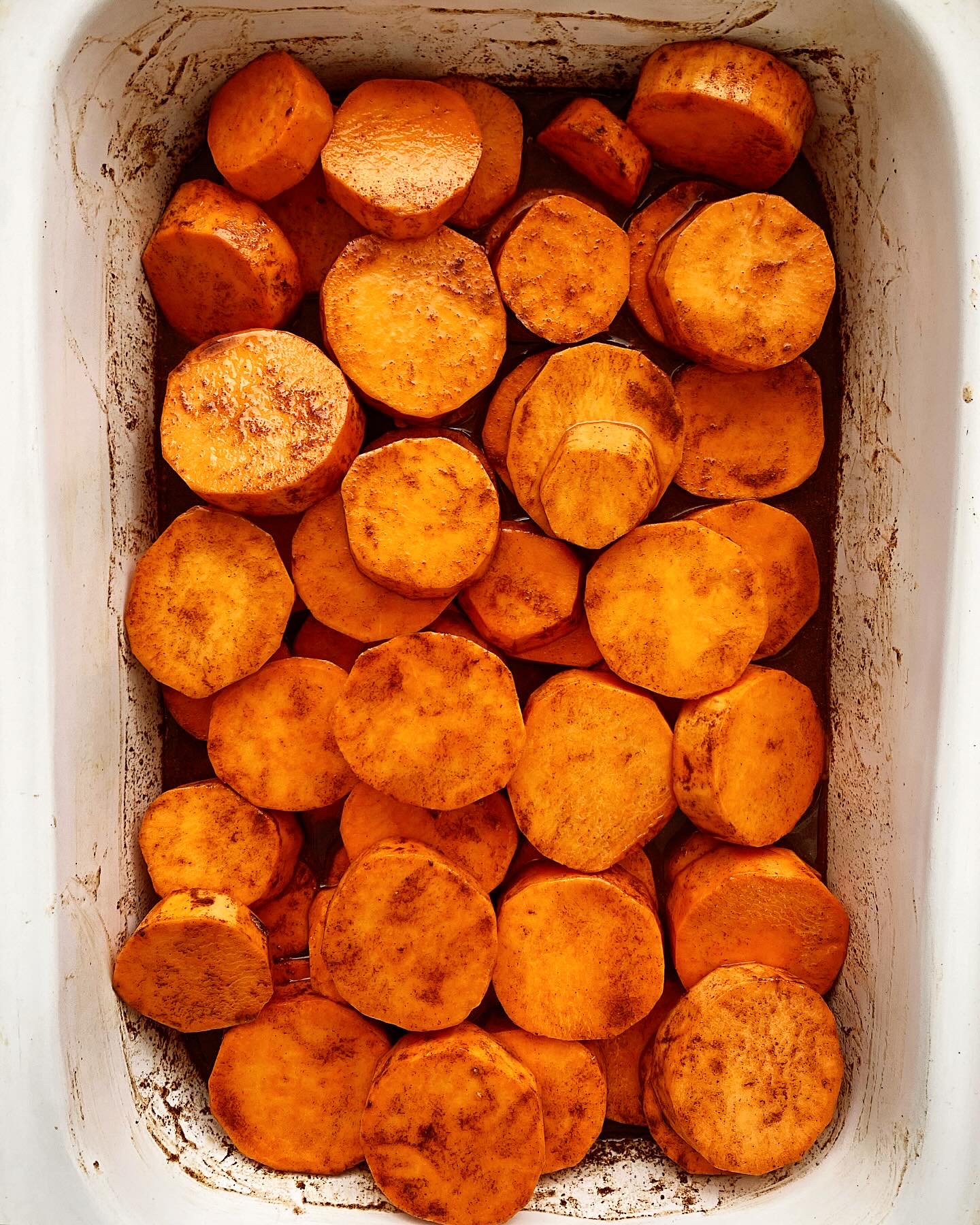 overhead shot of uncooked crockpot sweet potato casserole in a white casserole shaped slow cooker