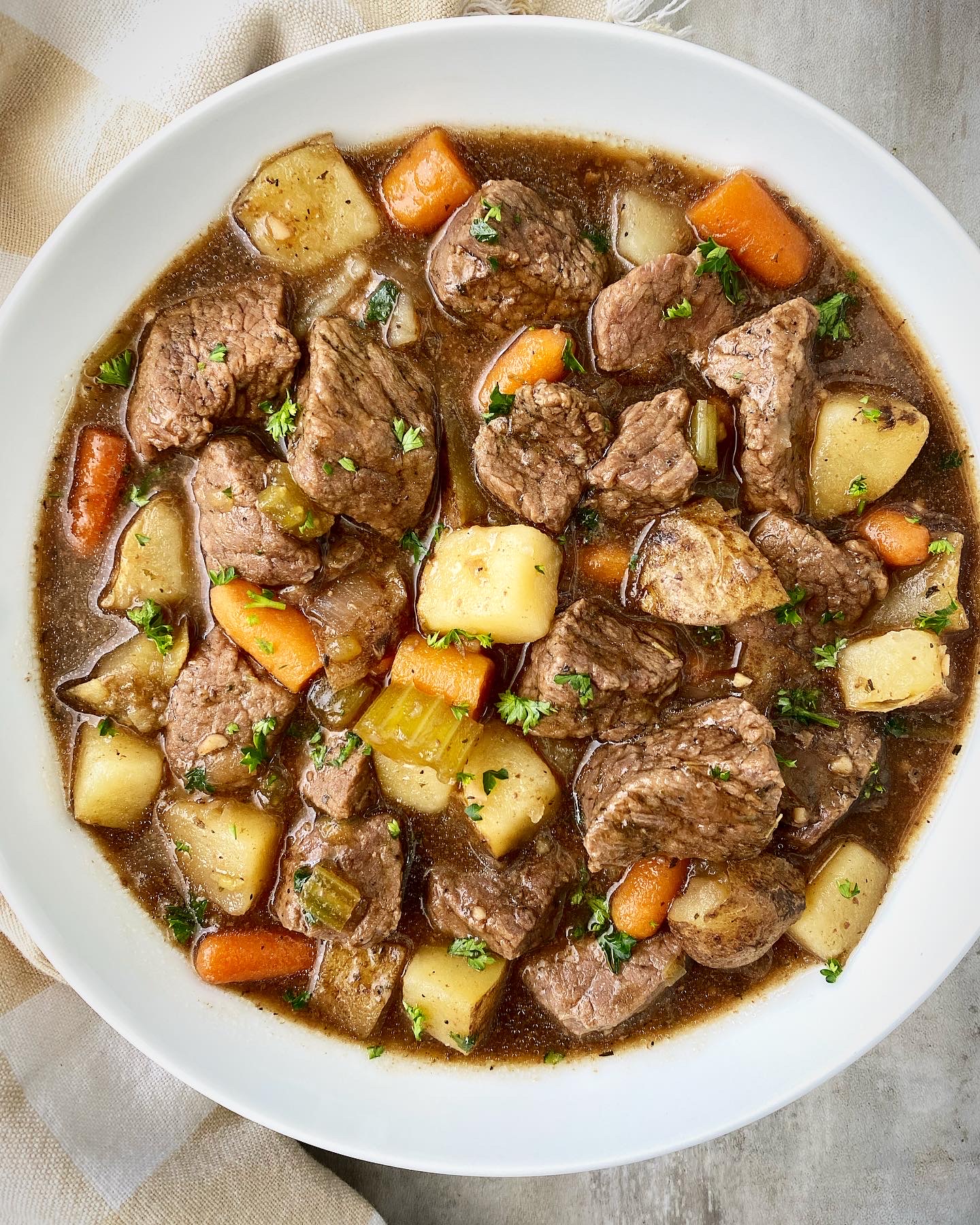 overhead shot of cooked Guinness beef stew in a white bowl
