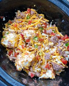 overhead shot of uncooked beef queso dip in the slow cooker