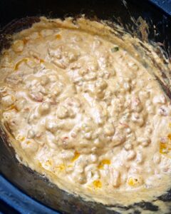 overhead shot of cooked beef queso dip in the slow cooker