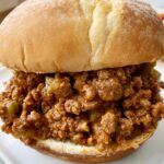 close up shot of sloppy joes on a white bun