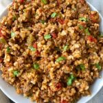 overhead shot of ground beef spanish rice in a white bowl