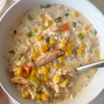 overhead shot of Crockpot Corn And Crab Chowder in a while bowl
