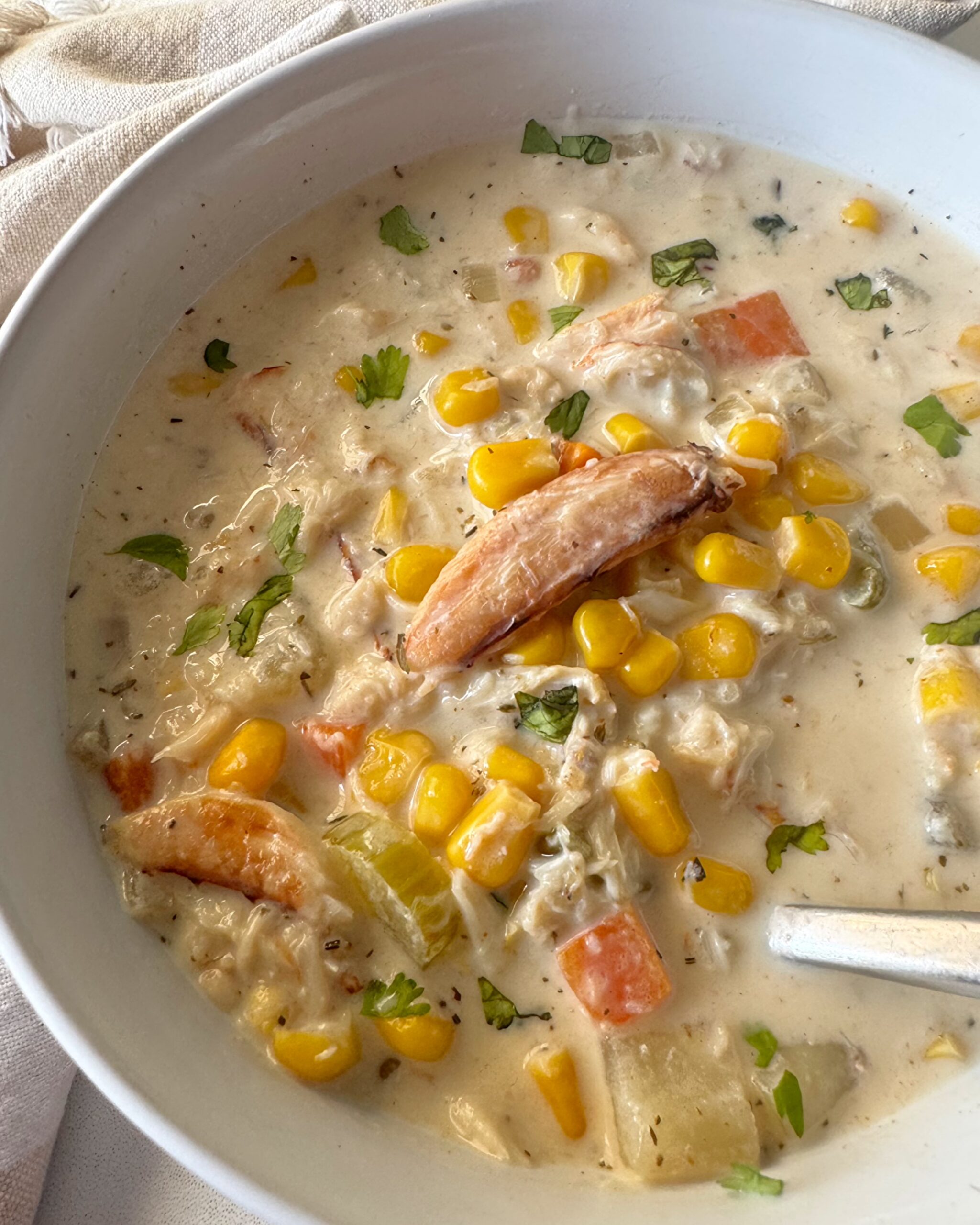 overhead shot of Crockpot Corn And Crab Chowder in a while bowl