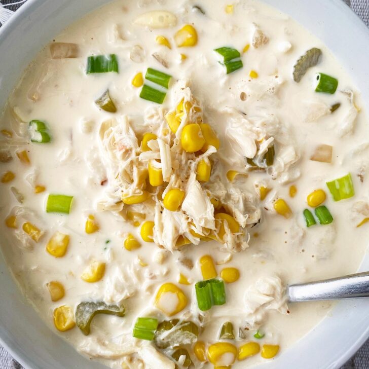 overhead shot of overhead shot of corn crab chowder in a white bowl
