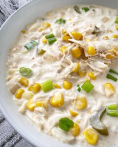 overhead shot of lose up shot of corn crab chowder in a white bowl