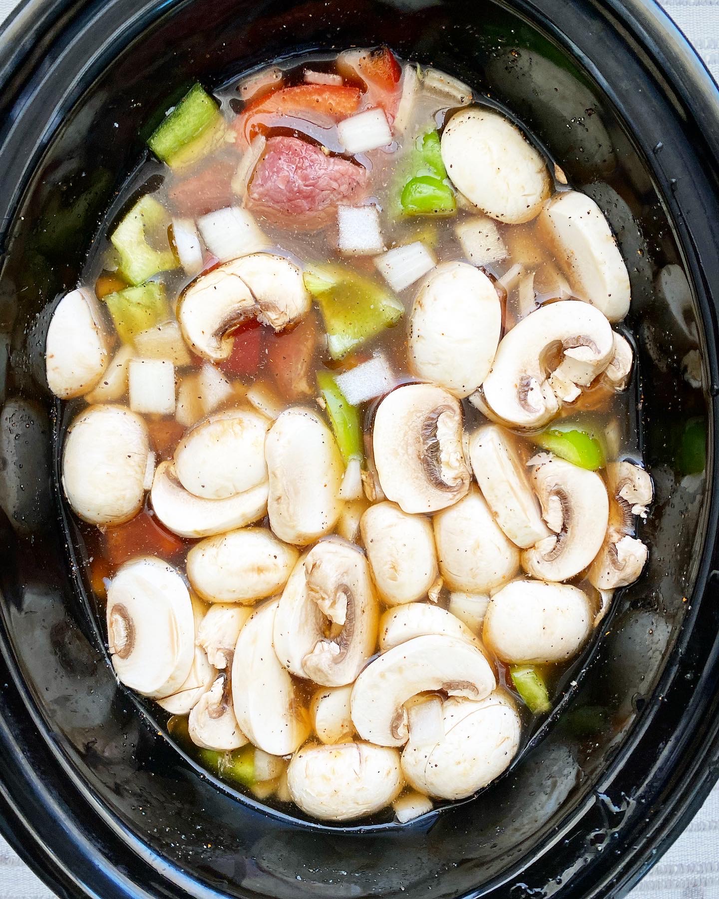 overhead shot of uncooked slow cooker cheesesteak soup