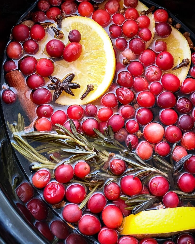 overhead shot of Simmering Holiday Potpourri in a black slow cooker
