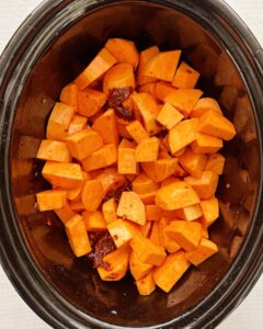 overhead shot of chipotle mashed sweet potatoes in a black slow cooker