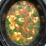 This slow cooker vegetable tortellini soup is a comforting  and flavorful dish that where simple soup vegetables like carrots, onion, and celery slow cook in a flavorful tomato broth. Add your favorite tortellini for a nourishing and satisfying soup! Whether you want a meatless meal or a hearty soup on a chilly day, this easy tortellini soup is the answer. Instructions to make this easy tortellini soup in the Instant Pot are also included. 