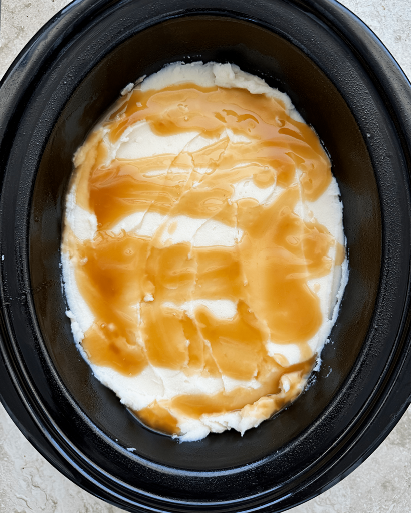 overhead shot of uncooked Leftover Thanksgiving Casserole in a black slow cooker