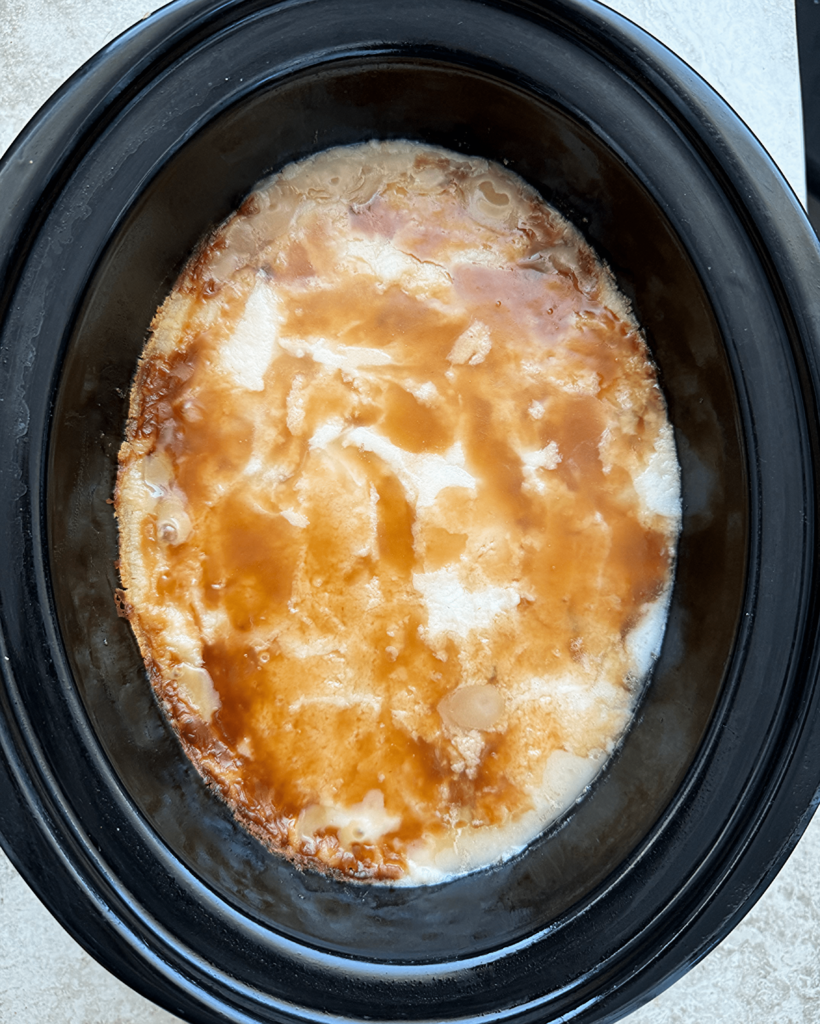 overhead shot of cooked Leftover Thanksgiving Casserole in a black slow cooker
