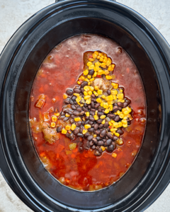 overhead shot of cooked tex mex beef roast in a black slow cooker