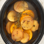 overhead shot of cooked Fall Potpourri in a black slow cooker