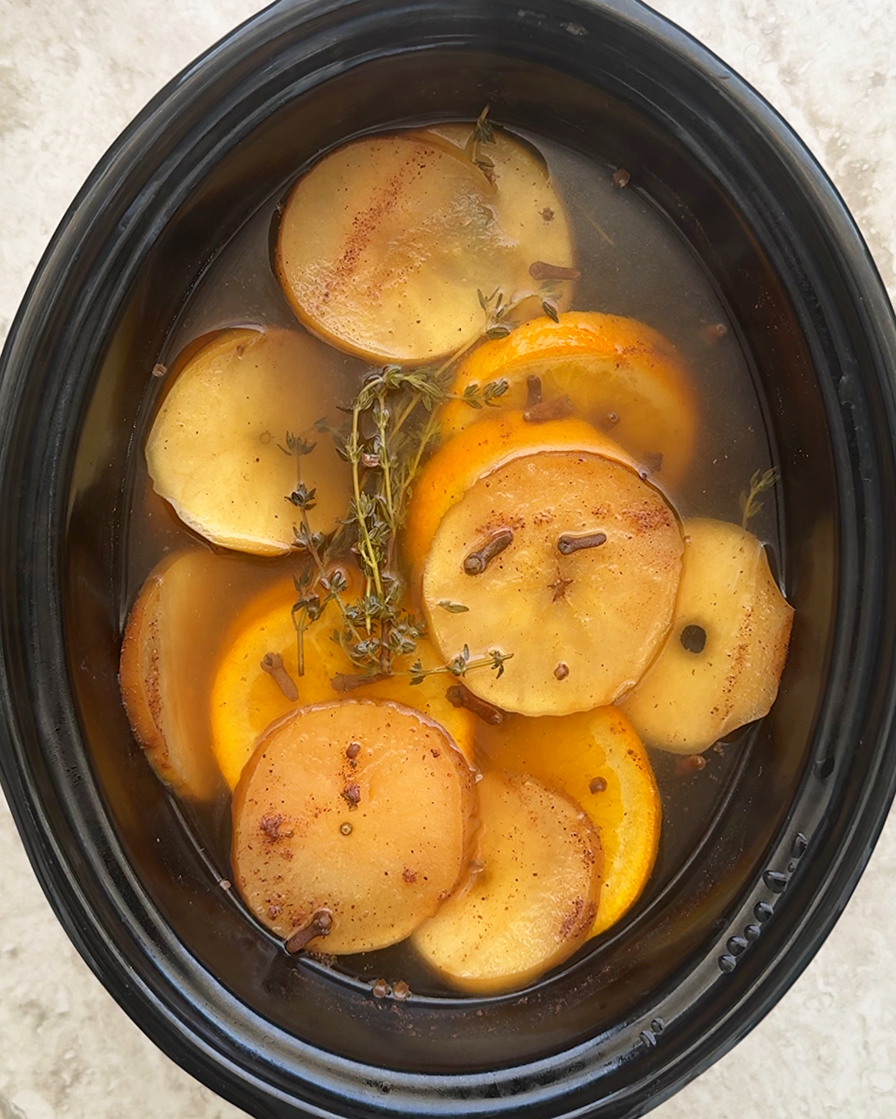 overhead shot of cooked Fall Potpourri in a black slow cooker