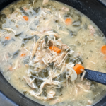 close up shot of Crockpot Leftover Holiday Soup in a black slow cooker