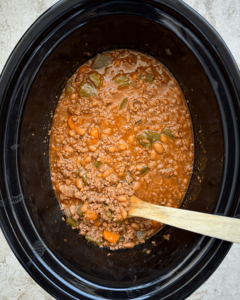 overhead shot of cooked chuck wagon stew in a black slow cooker