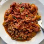 overhead shot of cooked Dolly's 5-Layer Dinner on a white plate with a silver fork
