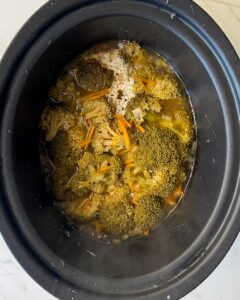 overhead shot of cooked Broccoli Cheddar Soup in a black slow cooker