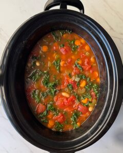 overhead shot of cooked ribollita in a black slow cooker