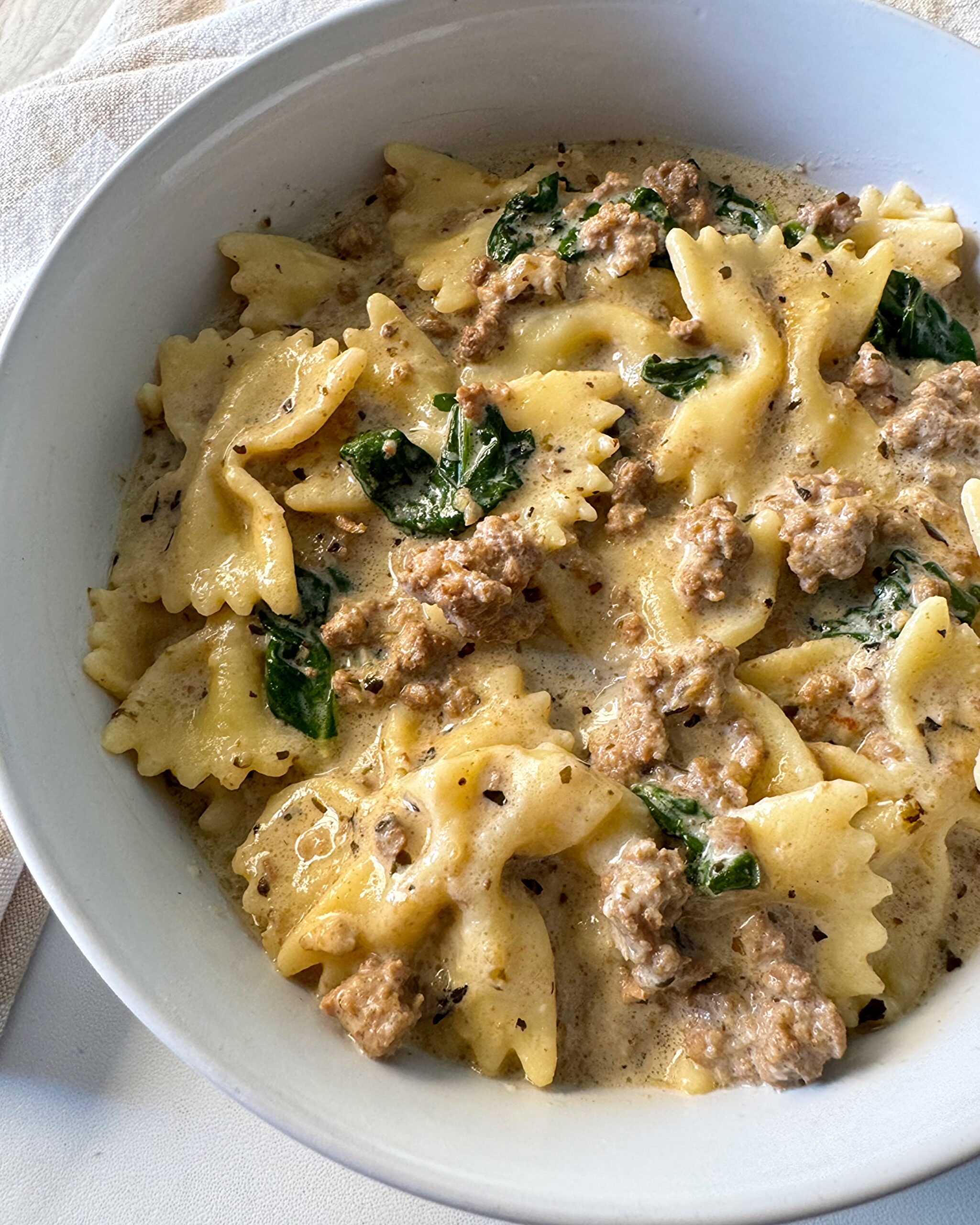 overhead shot of Crockpot Creamy Ground Beef Pasta on a white plate