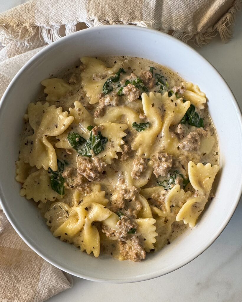 overhead shot of Crockpot Creamy Ground Beef Pasta on a white plate