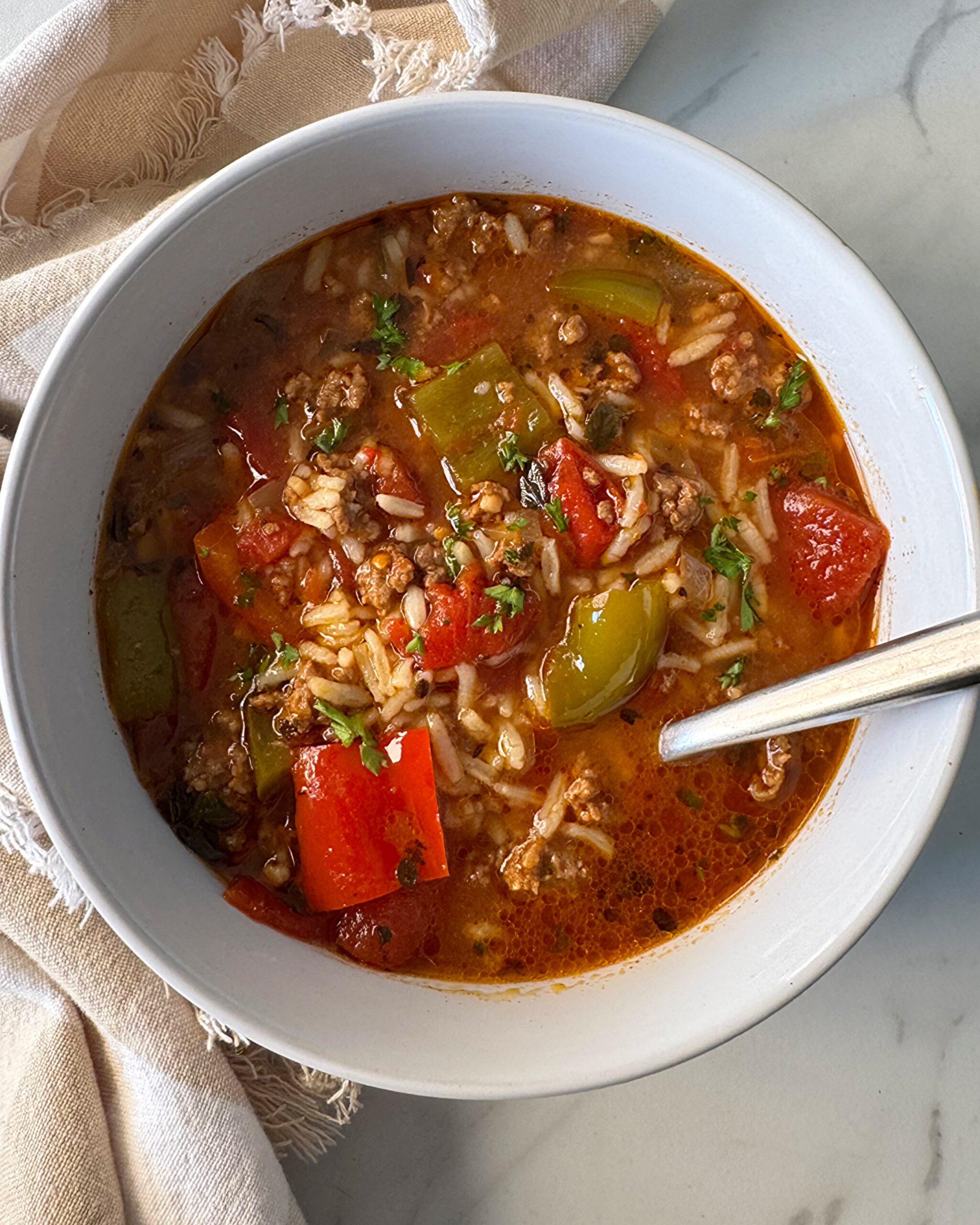 overhead shot of Stuffed Pepper Soup in a white bowl