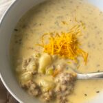 overhead shot of cheeseburger soup in a white bowl