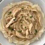 overhead shot of chicken and gravy over mashed potatoes
