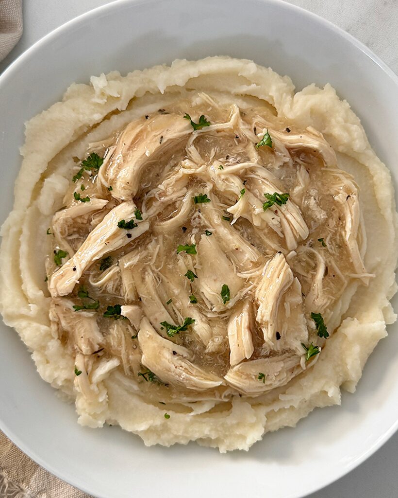 overhead shot of chicken and gravy over mashed potatoes