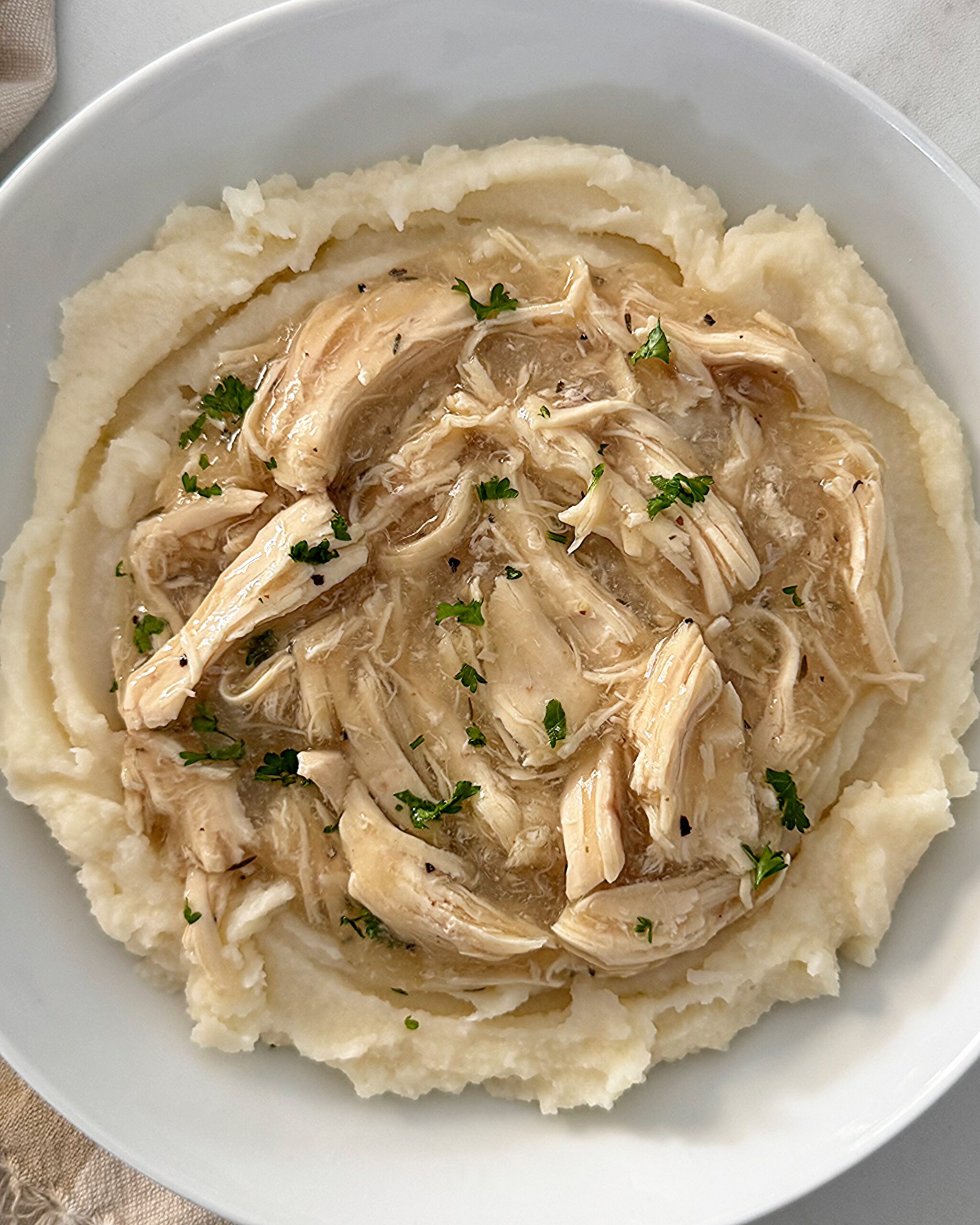 overhead shot of chicken and gravy over mashed potatoes