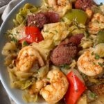 close up show of Crockpot Cajun Cabbage Sausage Shrimp on a white plate