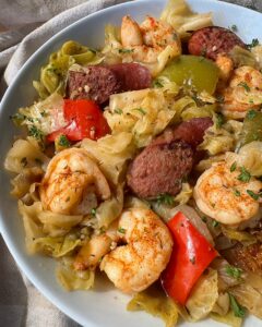 close up show of Crockpot Cajun Cabbage Sausage Shrimp on a white plate