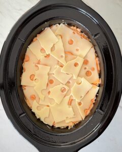overhead shot of uncooked Reuben Casserole in a black slow cooker