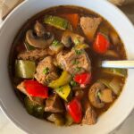 overhead shot of beef kebab soup in a white bowl
