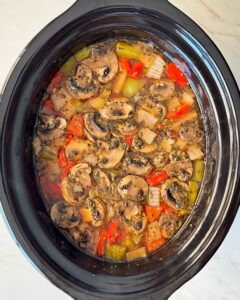 overhead shot of cooked beef kebab soup in a black slow cooker