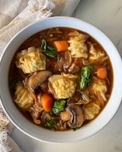 overhead shot of Slow Cooker Potsticker Soup in a white bowl